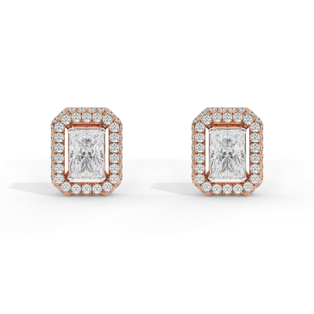 A pair of rectangular stud earrings featuring emerald-cut center stones surrounded by a halo of small round stones in a rose gold setting, shown on a clean white background.