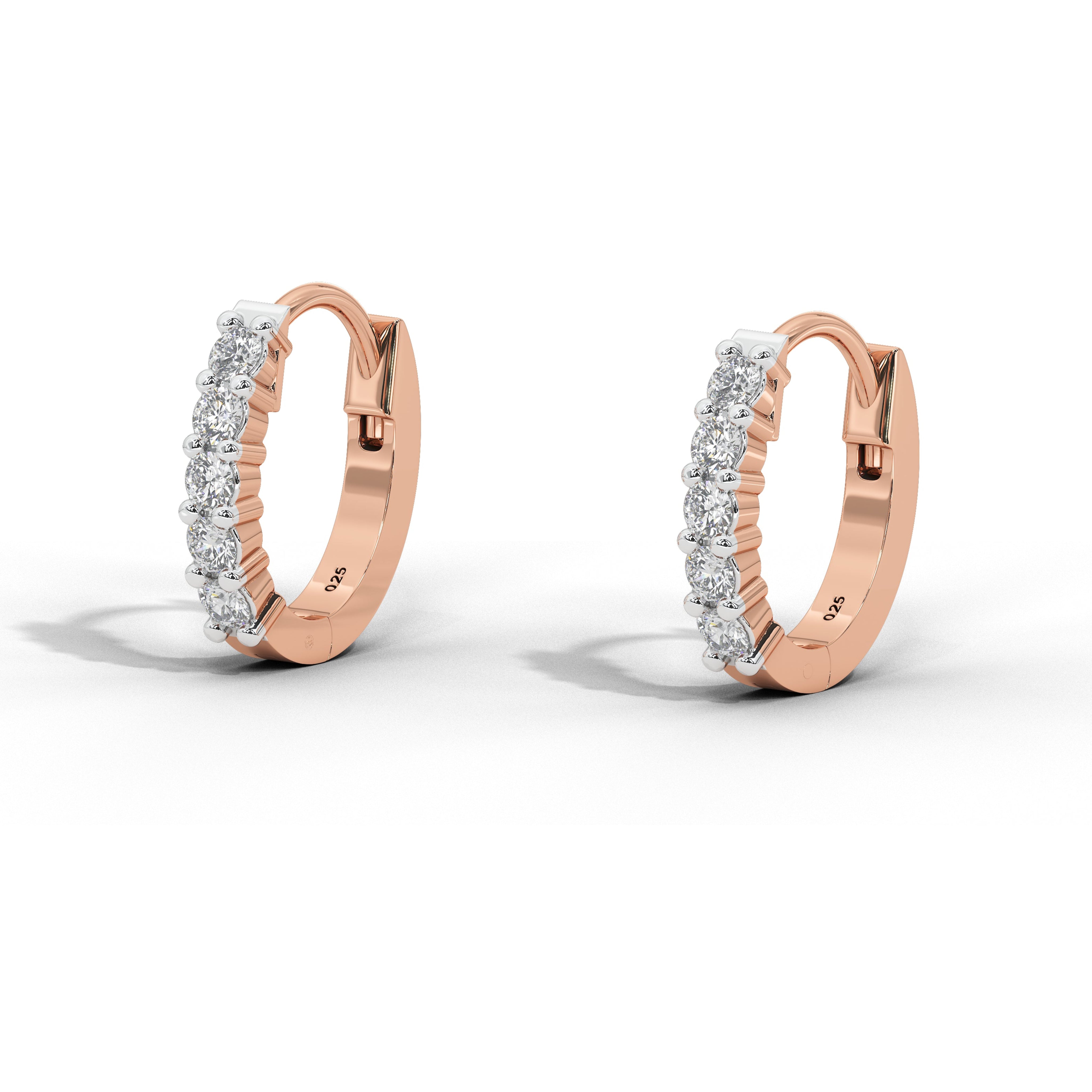 A pair of rose gold huggie hoop earrings with a row of small clear diamonds on the front, displayed on a clean white background with soft shadows.