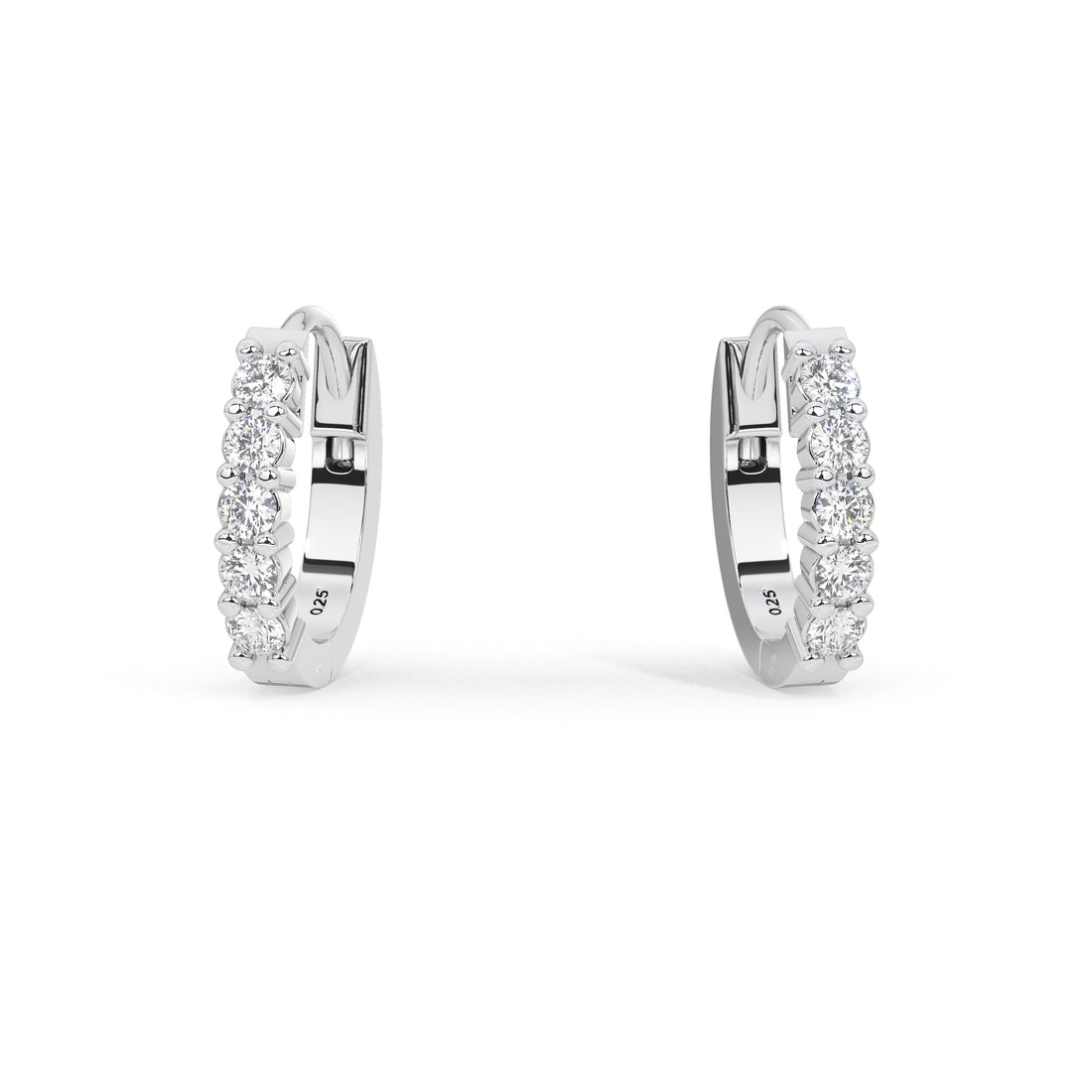 A pair of white gold huggie hoop earrings set with clear pavé diamonds, shown against a plain white background.