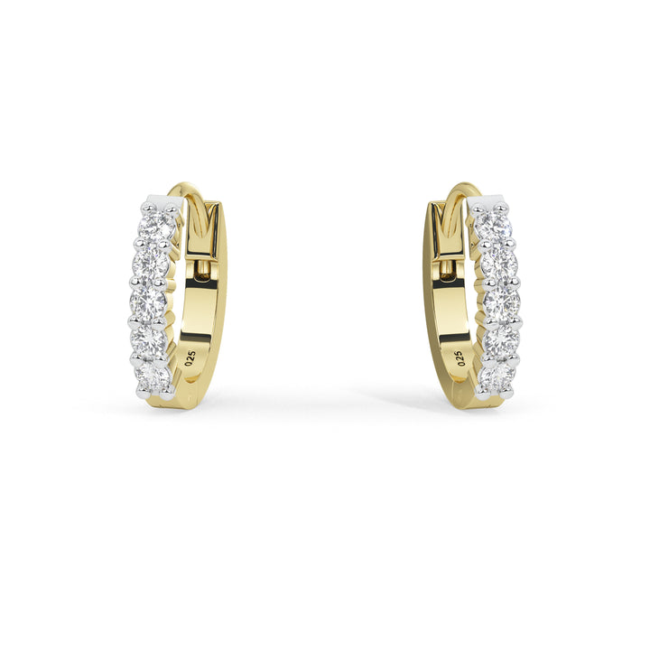 A pair of gold huggie hoop earrings set with clear pavé diamonds, shown on a clean white background.