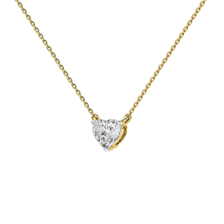 A delicate yellow gold chain necklace with a small heart-shaped diamond pendant, shown against a solid white background.