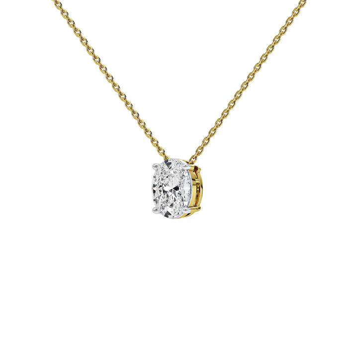 A yellow gold chain necklace with a small pendant featuring a clear oval diamond in a gold setting, shown against a plain white background.